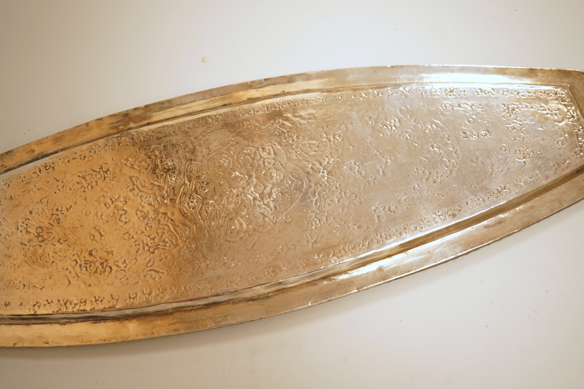 A set of six 20th century Middle Eastern white metal tots, 42mm and matching tray, 25.2cm, all engraved with geometric foliate decoration.